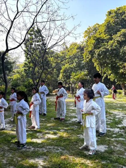 Young karate students practicing their stances during an outdoor training session. Discipline and focus are built both inside and outside the dojo.