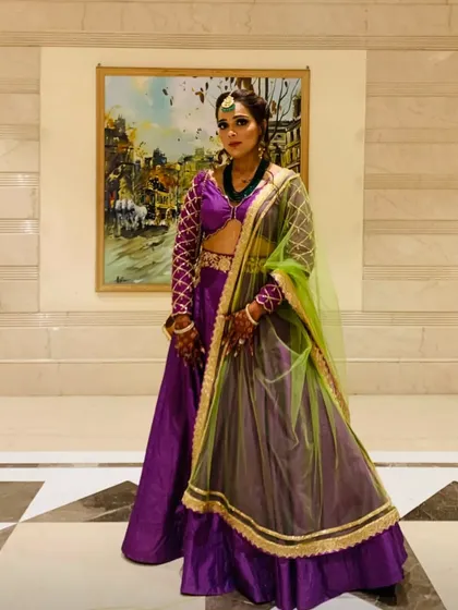 Confidence is the best accessory. Here, I'm showcasing a complete festive look with a purple and green lehenga, complete with a maang tikka and coordinated jewelry for a polished, event-ready appearance.