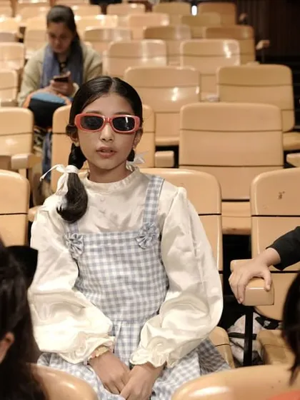 "Alice" looking cool in sunglasses while waiting in the auditorium. Even during downtime, the fun and character play continues.
