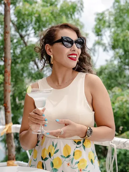 A vibrant lifestyle shot for a hospitality client in Hyderabad. This image captures the essence of a relaxed, sunny afternoon, using bright colors and a candid moment to sell an experience.