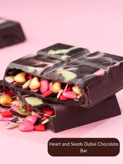 A close-up of the Heart and Seeds Dubai Chocolate Bar. This viral treat is filled with colorful seeds, offering a unique and crunchy texture.