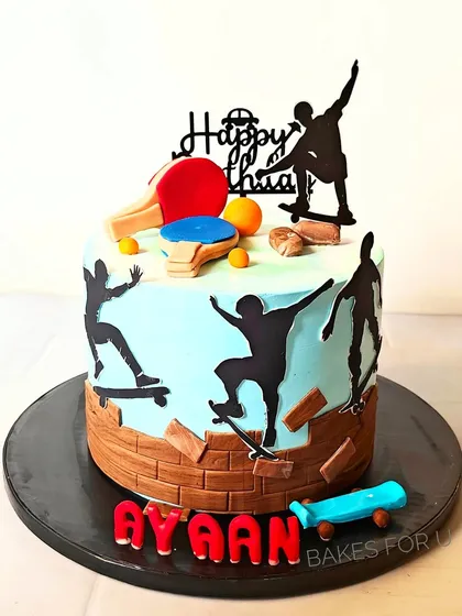 A dynamic cake for someone who loves both skateboarding and table tennis. The design features silhouettes of skateboarders and a miniature, edible ping-pong table.