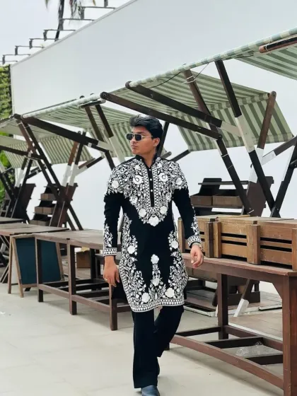 Another shot of the black and white floral kurta in a modern setting.