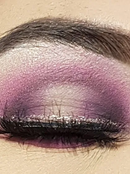 This is a purple halo eye look I created. The technique involves placing a darker shadow on the inner and outer corners of the eyelid and a light, shimmery shade in the center to make the eyes look bigger and brighter.