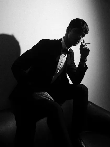 Light is a tool for sculpting. Here, I used a single, hard light source to create this high-contrast silhouette. This black and white portrait is all about mood, shape, and the drama created by deep shadows.
