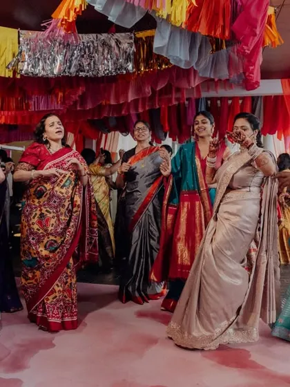 Guests dancing under a colorful canopy of draped fabrics and streamers. We created a festive and joyful atmosphere where everyone felt inspired to join the celebration.