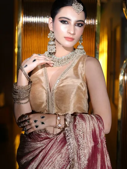 Another angle of this beautiful party look, highlighting the intricate hand jewelry and makeup.