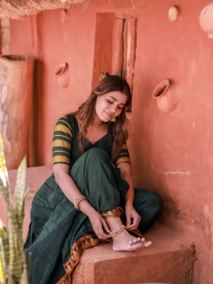 Portraits of a model in a green dress, captured in a traditional house setting. The warm, earthy tones of the location complement the outfit and create a peaceful, grounded mood.