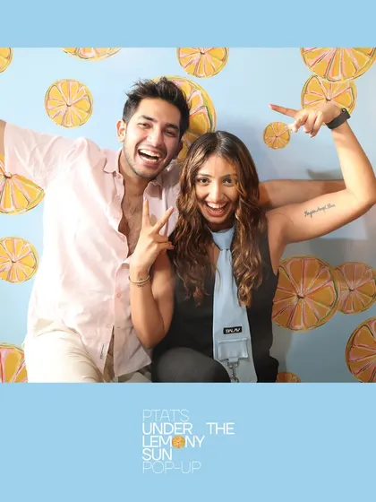 A couple having fun and posing for the camera at the PTAT pop-up. Our booths are a great activity for couples and friends to enjoy together.