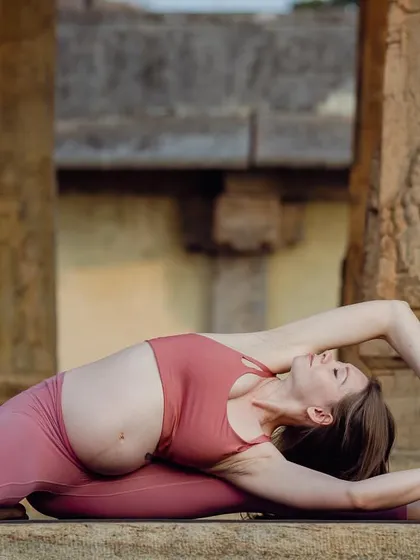 A modified Parighasana (Gate Pose) during my pregnancy. It's crucial to adapt the practice to listen to your body's changing needs, creating space for the baby while still finding movement.