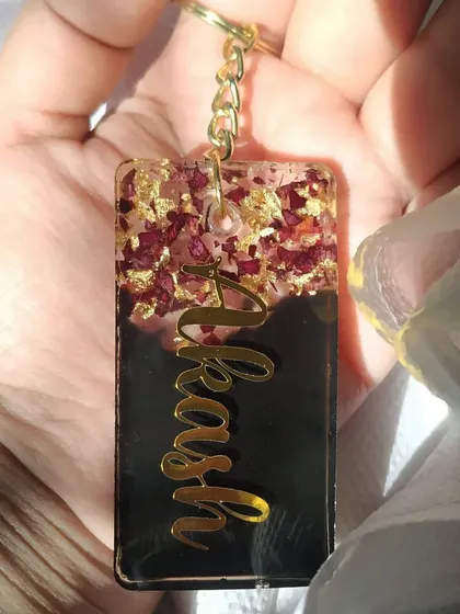 Here is another look at the personalized name keychain with preserved rose petals. The contrast between the dark background and the gold lettering makes the name stand out beautifully.