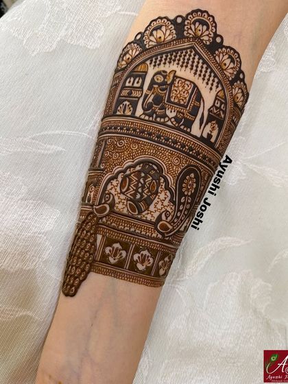 A close-up of a completed armband, showing the fine details of the royal elephant and the surrounding patterns.