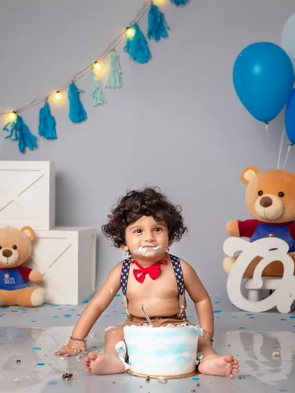 Yummy, yummy, cake in my tummy! This little boy is all smiles, with cake and frosting everywhere.