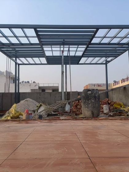 A wide shot of a pergola frame under construction in Gurugram, Sector 4.