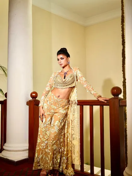 A full-length view of the golden co-ord set. The styling is modern and chic, perfect for a festive event or a stylish party.