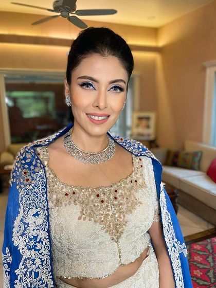 A striking look for this beauty. I paired a sharp blue winged liner with luminous skin and a natural lip for a look that is both bold and incredibly chic.