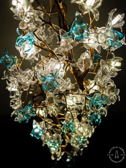 This enchanting chandelier is a bouquet of light, composed of dozens of hand-blown glass flowers in clear and soft blue hues. The intricate design creates a magical, garden-like atmosphere, perfect for a romantic bedroom or elegant dining space.
