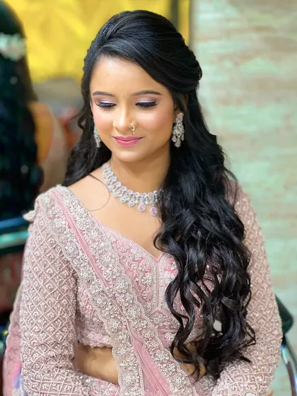 A close-up showing the half-up hairstyle and the elegant diamond earrings. This is a great example of a complete, polished engagement look.