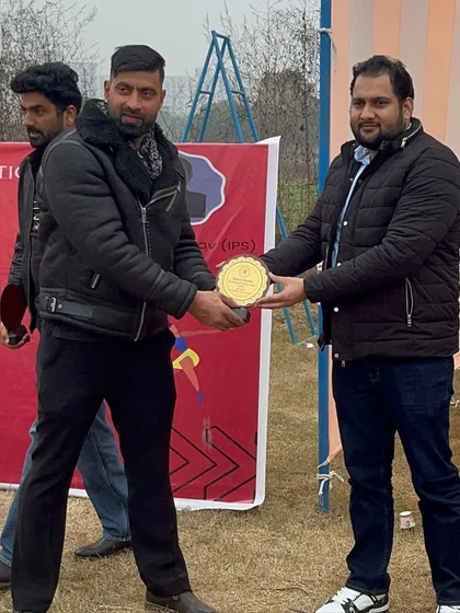Receiving an award at a local athletics event. It's an honor to be recognized for my dedication to coaching.