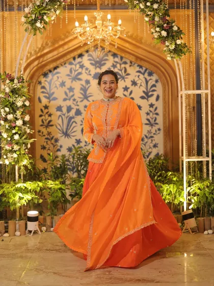 A happy, twirling shot in a stunning orange lehenga. This was taken at 3 am, showing my commitment to keeping the energy alive throughout the entire wedding celebration.