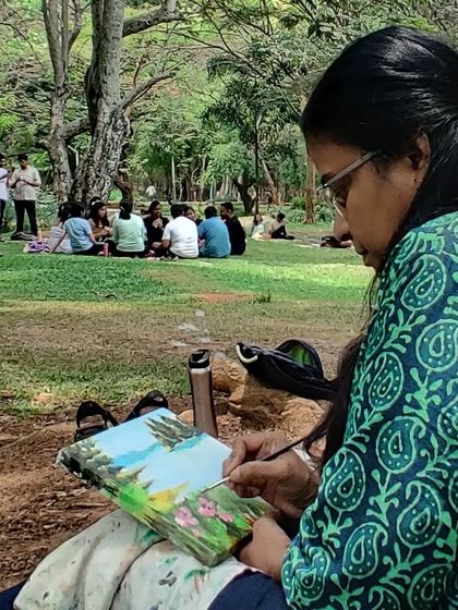 A side view of me painting, showing the peaceful and focused nature of our outdoor art sessions.