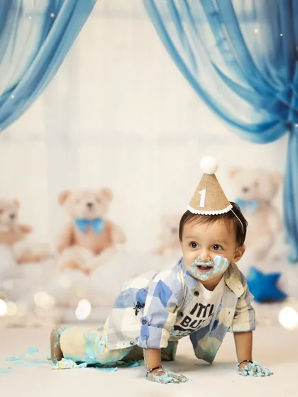 Even with cake on his face, he's on the move! This crawling shot shows his playful energy during the cake smash. We love capturing these action shots that show your baby's personality.