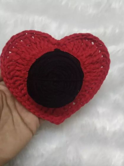 A classic red heart scrunchie. This is a perfect accessory for adding a pop of color to a ponytail or bun.