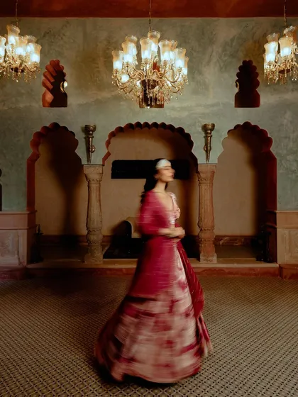 An atmospheric shot for designer Ruhr, using motion blur to capture a model in a grand, traditional room. The movement conveys a sense of dreaminess and elegance.