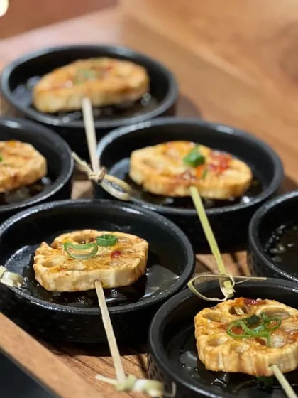 Skewers of pan-seared lotus stem, a unique and flavorful appetizer that is always a conversation starter.