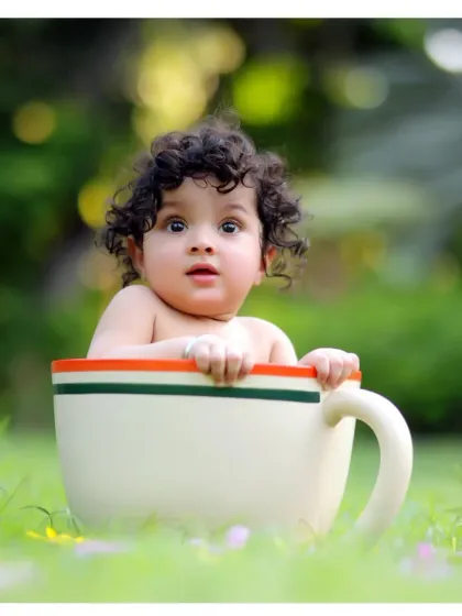 A straight-on shot of our adorable teacup baby, with beautiful, soft background blur from the natural park setting.