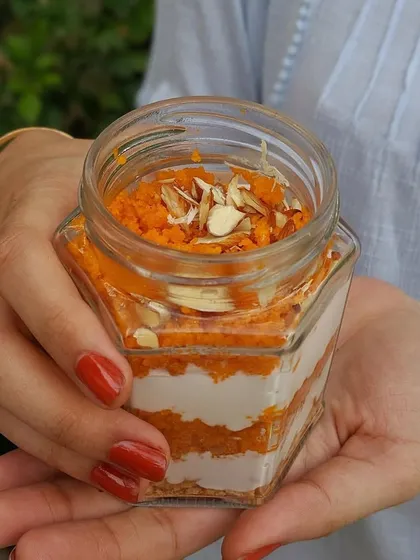 Our Motichoor Laddoo Cream Cheese Jar, with layers of creamy cheesecake, crushed boondi laddoo, and a biscuit crust, garnished with almond shavings.