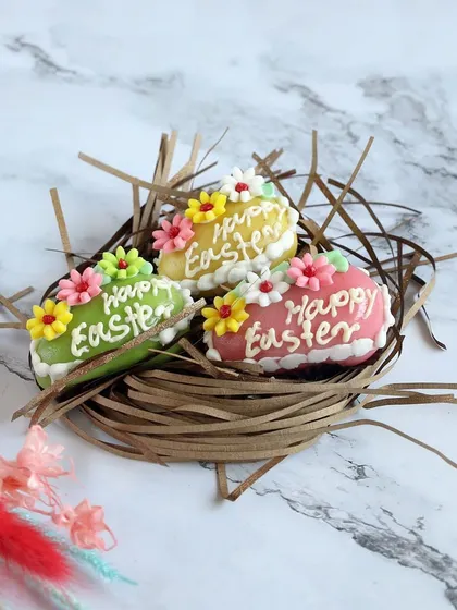 These colorful Easter egg chocolates are hand-decorated with "Happy Easter" greetings and floral designs, making them a beautiful and personal gift.