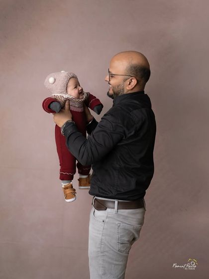 In his arms, the whole world feels safe. This touching portrait of a father holding his baby captures the strength and tenderness of a dad's love.