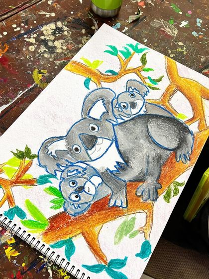 The finished koala family artwork! A proud result of patience and practice, showing a completed drawing with a vibrant background.
