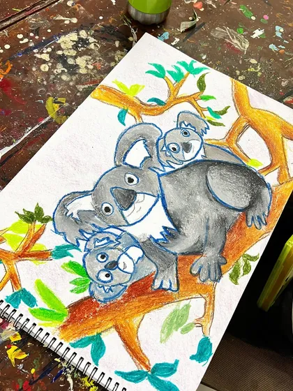 The finished koala family artwork! A proud result of patience and practice, showing a completed drawing with a vibrant background.