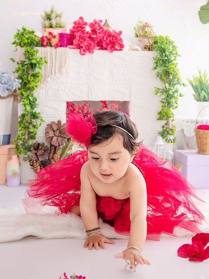 On the move. This crawling shot captures the exploratory nature of a baby girl in a beautiful red tutu.