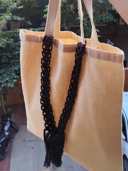 The cotton tote bag shown outdoors, highlighting its natural texture and handmade details. It's both a practical and an eco-friendly fashion statement.