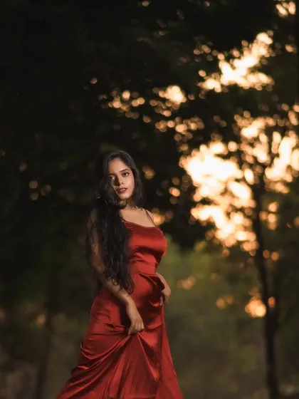 An outdoor portrait session where the sunset, the location, and the red dress came together perfectly. I used the trees to create a beautiful, blurry bokeh effect that makes the subject stand out.