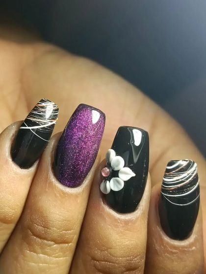 I am obsessed with this intricate set. It combines black nails with a 3D white flower, a purple cateye accent, and delicate thread art.