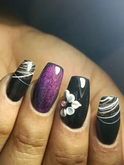 I am obsessed with this design. It combines black polish, purple glitter, 3D floral art, and a delicate thread art design.