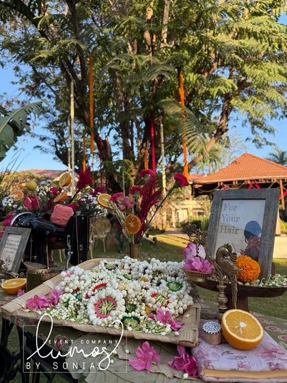 A wide shot of the jasmine flower station, beautifully styled with an antique sewing machine and vibrant floral arrangements.