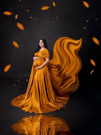Another stunning shot of the golden-yellow fabric toss, capturing the movement and flow of the gown.