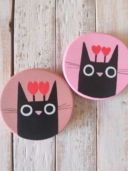 For the cat lovers. These cute magnets feature a black cat with hearts, a simple and sweet way to show your affection.