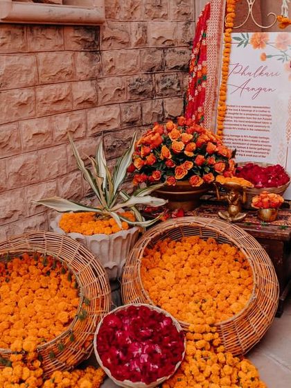 Baskets of fresh marigold and rose petals ready for the Haldi ceremony, adding to the vibrant, festive atmosphere.