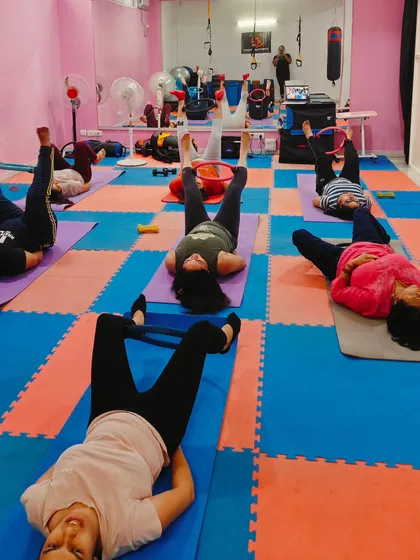 Another angle of our Pilates class, showing the full-length mirror which is crucial for checking alignment and posture.