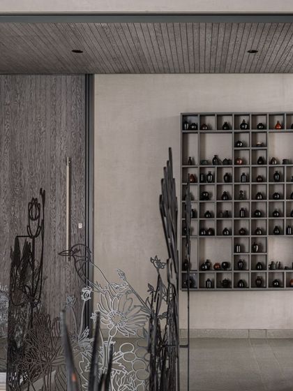 This image shows the 'Kalrav Seasons' railing in context with other interior elements, including a custom shelving unit, illustrating how our art can complement various design styles.