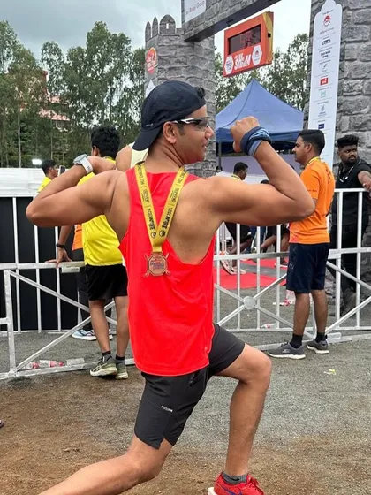 Flexing after the finish line. The strength training pays off on race day.