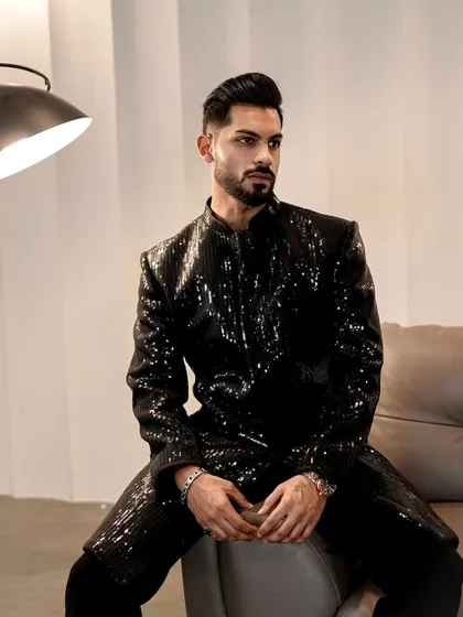 For your cocktail nights and sangeets, we created this fully sequined black Indo-Western jacket. The sharp tailoring and shimmering texture make it a definitive statement piece, designed to catch the light and command attention.