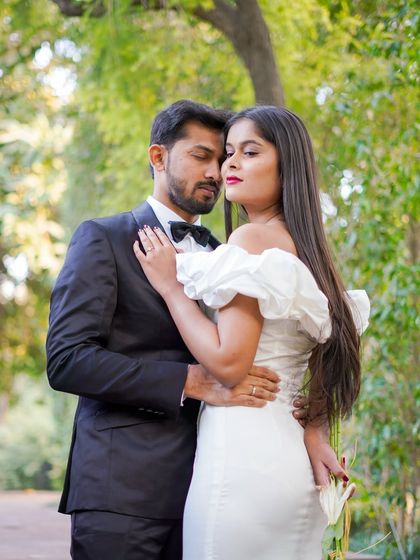 An intimate embrace in a beautiful garden setting. The soft focus on the background foliage draws all the attention to the couple's connection.