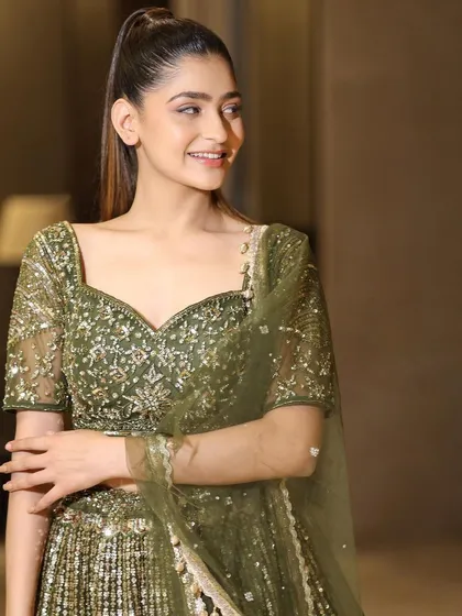 A happy and radiant portrait in our olive green lehenga. This outfit is sure to make any wedding guest feel beautiful and confident.